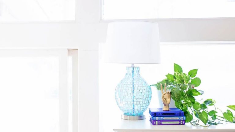 White Table Lamp on Sideboard Near Plant
